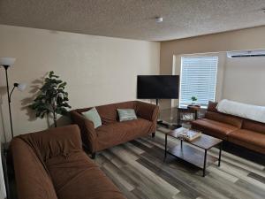 a living room with two couches and a flat screen tv at Marine B Two Bedrooms One-Half Bathrooms Townhouse in Everett