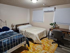 a bedroom with two beds and a desk and a bed sidx sidx sidx at Marine B Two Bedrooms One-Half Bathrooms Townhouse in Everett