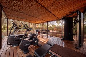 a gym with two treadmills and exercise equipment on a wooden deck at Can Simoneta - Adults Only in Canyamel