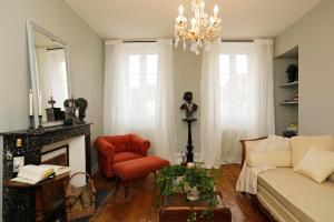 a living room with a couch and a fireplace at Villa La Poste 