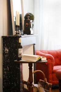 a table with a bottle of wine and a book at Villa La Poste  +2 photos