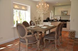 a dining room with a wooden table and chairs at LITZKOW 15005 in Morsum +13 photos