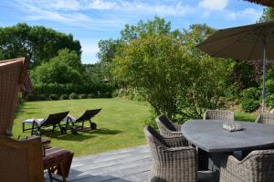 a patio with a table and chairs and an umbrella at LITZKOW 15005 in Morsum