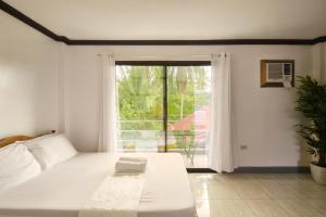 Postel nebo postele na pokoji v ubytování Yayay Siargao