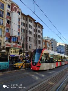 a red and white train traveling down a city street at Hotel Bazaar in Istanbul