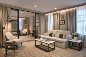 a living room with a couch and a table at Radisson Blu Hotel, London Bond Street in London