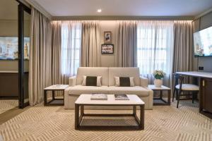 a living room with a couch and a table at Radisson Blu Hotel, London Bond Street in London +91 photos