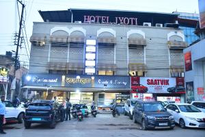a building with cars parked in front of it at Raj Gharana in Raipur