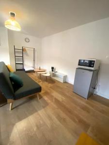 a living room with a couch and a table at ღ Le Nid Douai - T2 Proche Centre Ville & Gare in Douai
