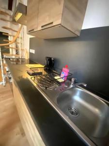 a kitchen counter with a sink and a stove at ღ Le Nid Douai - T2 Proche Centre Ville & Gare in Douai