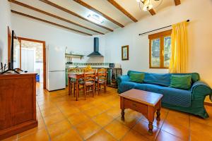 a living room with a couch and a table at El Molinet del Governador- Apartamentos Rurales in Guadalest