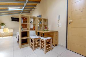 a room with a desk and stools in a room at Sunny Skylight Loft! in Ágios Rókkos +3 photos