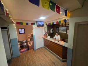 a man standing at a bar in a restaurant at Hotel Pokhara Peace in Kathmandu +18 photos