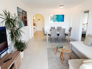a living room with a table and a couch at Beach Front Sea View Punta Prima in Punta Prima