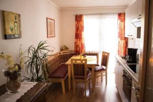 a small kitchen with a table and a dining room at Pizzeria Prosser - Appartements in Dienten am Hochkönig