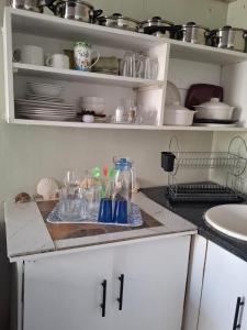 a kitchen with a counter with dishes on it at The Albertyns in Belhar