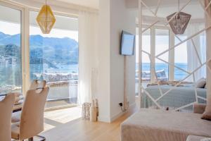 a bedroom with a bed and a large window at The Dream Getaway SkyLine by DeVasco in Bečići +48 photos