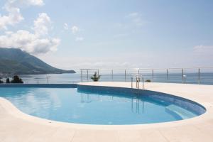 a swimming pool with a view of the water at The Dream Getaway SkyLine by DeVasco in Bečići