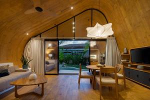 a living room with a couch and a table at Cheria Eco Lodge in Selong Belanak