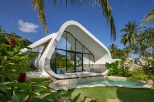 a modern house with a slide in a garden at Cheria Eco Lodge in Selong Belanak