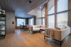 a living room with two couches and a table at Hoven Lodge in Vik +63 photos