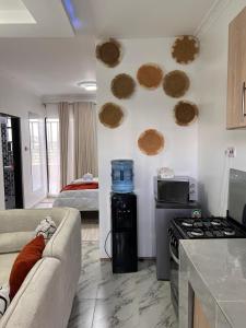 a living room with a couch and a stove and a bed at Studio in Nanyuki with Mount Kenya Views in Nanyuki