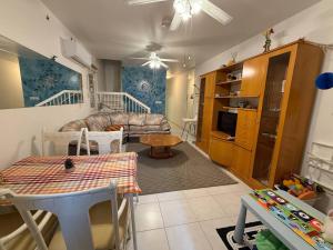 a living room with a couch and a table at Villa Clementinka - 200 meters from the sea in Chlorakas