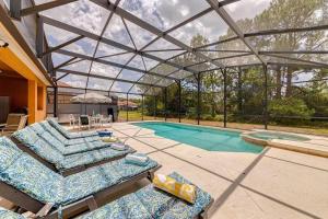a house with a swimming pool with a glass roof at Watersong Sunbreeze Villa in Davenport