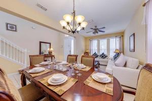 a dining room and living room with a table and chairs at Watersong Sunbreeze Villa in Davenport