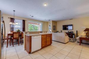 a kitchen and living room with a couch and a table at Watersong Sunbreeze Villa in Davenport