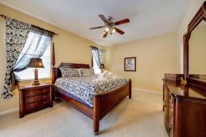 a bedroom with a bed and a ceiling fan at Watersong Sunbreeze Villa in Davenport +32 photos