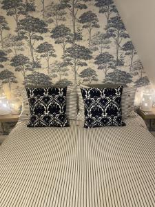 a bedroom with a bed with black and white pillows at Harbour House Bristol Entire townhouse with harbour views, sleeps up to 7 people in Bristol