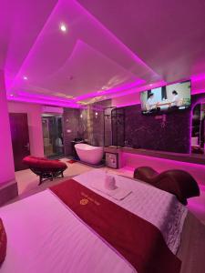 a bedroom with a bed with purple lights on it at Khách Sạn Hoa Vinh - Thủ Đức in Ho Chi Minh City +42 photos