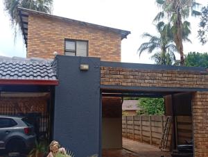 a house being remodeled with a brick wall at El Elyon Lodge in Pretoria