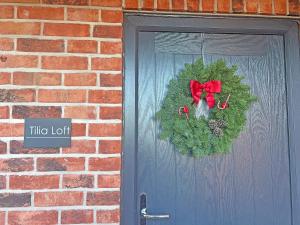 a christmas wreath on the door of a house at Tilia Loft in Scotter +15 photos