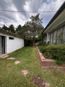 a yard with a tree next to a building at Casa - Chalet Valle del Reposo in Bialet Massé +35 photos