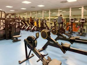 a gym with a bunch of treadmills and machines at Hotel Pathos by Mimood Aparthotels in Valencia