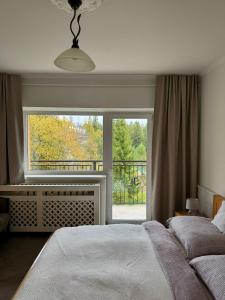 Vila Nezábudka 206, Tatranská Štrba في تاترانسكا ستربا: غرفة نوم بها سرير ونافذة كبيرة +20 صورة