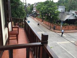 a balcony with a view of a city street at Villa Champa in Luang Prabang