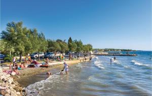 a group of people on a beach near the water at Gorgeous Home In Zaton in Zaton