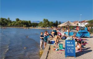 a group of people on a beach with the water at Gorgeous Home In Zaton in Zaton