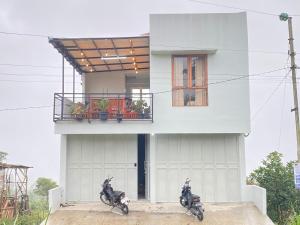 two motorcycles parked in front of a house at Fatmara Villa Full House in Kejajar