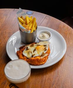 a plate with a sandwich and french fries and a drink at The Red Lion in Thames Ditton +15 photos