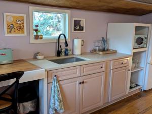 a kitchen with a sink and a window at Peaceful Eclectic Mountain Cabin with Screened Porch Near Black Mountain | Black Mountain, NC in Montreat
