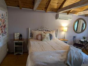 a bedroom with a large bed and a mirror at Peaceful Eclectic Mountain Cabin with Screened Porch Near Black Mountain | Black Mountain, NC in Montreat +26 photos