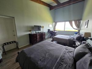 a bedroom with two beds and a television in it at Scenic Lakeside Getaway with Lake Views Near Gunstock & Weirs Beach | Laconia, NH in Weirs Beach +13 photos