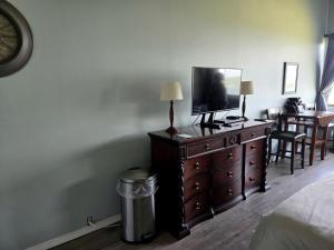 a bedroom with a dresser with a television on it at Relaxing Lakeside Getaway with Stunning Lake Views Near Gunstock | Laconia, NH in Weirs Beach +13 photos