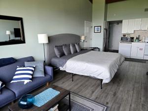 a bedroom with a large bed and a couch at Relaxing Lakeside Getaway with Stunning Lake Views Near Gunstock | Laconia, NH in Weirs Beach