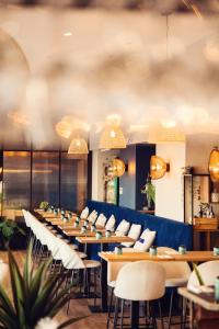 a row of tables and chairs in a restaurant at HOTEL RESTAURANT LA COTE REVEE in Leucate +41 photos