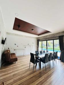 a dining room with a table and chairs at Share pool 1 room 2 bedroom in Ao Nang 